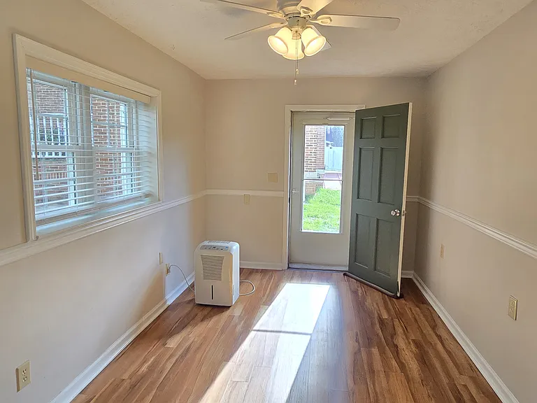 Bedroom 1 with exit access to small back patio