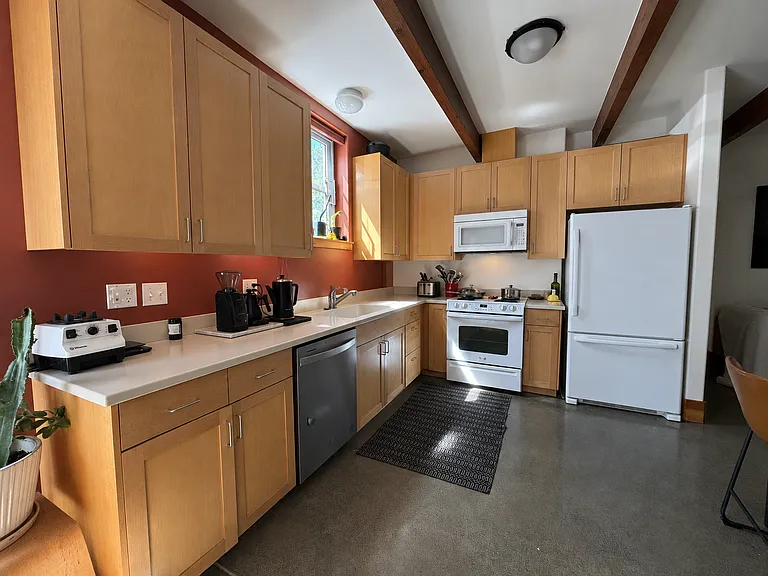 Kitchen: Solid maple cabinets, gas range, lots of storage space (plus a separate two-door pantry closet).