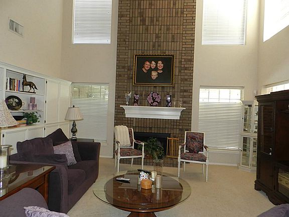 Family room w/soaring 2-story ceiling, Gas log fireplace bricked to ceiling.
