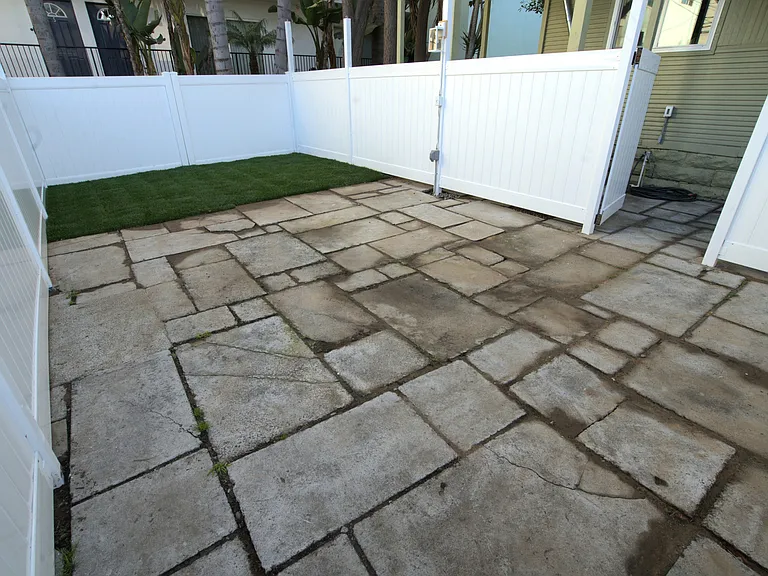Large private fenced backyard with lighting and electrical outlets assigned to unit D.