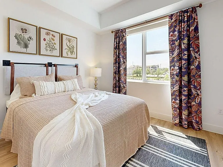 Experience the charm of this beautifully appointed bedroom, filled with natural light and decorative touches.