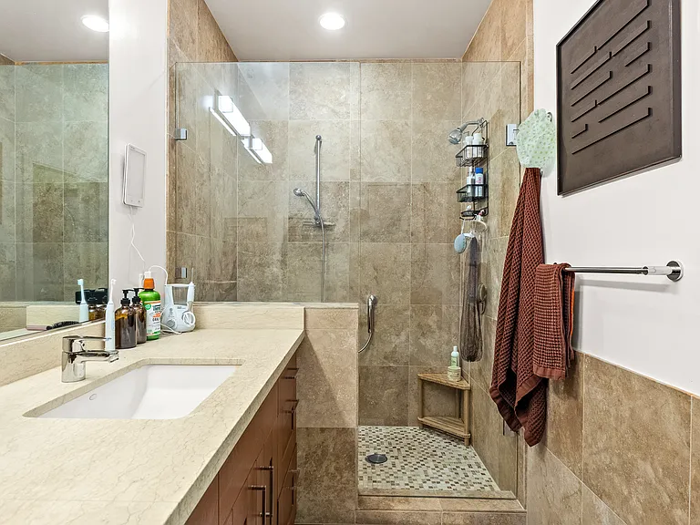 Walk-in shower in en suite bathroom for primary bedroom