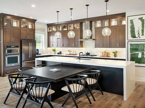 Gourmet kitchen includes large center island, ample counter and cabinet space, and pantry storage
