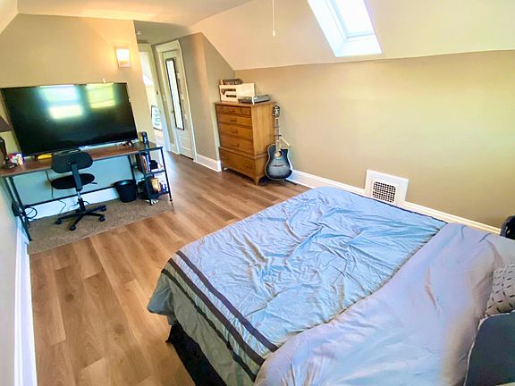 Bedroom #3 with NEW waterproof hardwood flooring installed in 2020, skylight, and plenty of room for home office