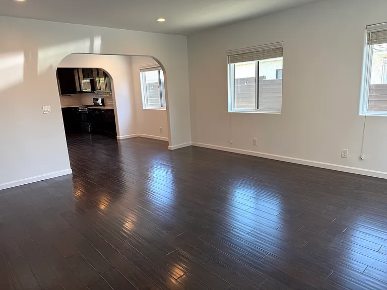 Bright living room filled with natural light and dimmable recessed LED lighting.