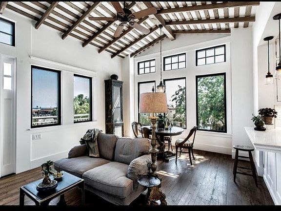 Living room and dining room adorned with windows .