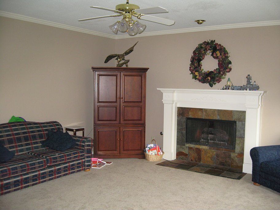 Living Room with new carpet, paint and custom fireplace!  Hidden DVD cabinets.
