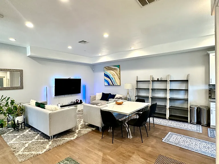 Open-concept living and kitchen with wood floors and natural light