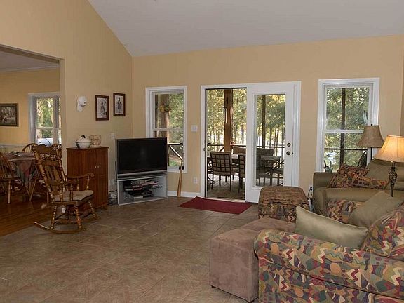 Open floor plan
						:
						Living area has cathedral ceiling, opens to kitchen and screened porch.
