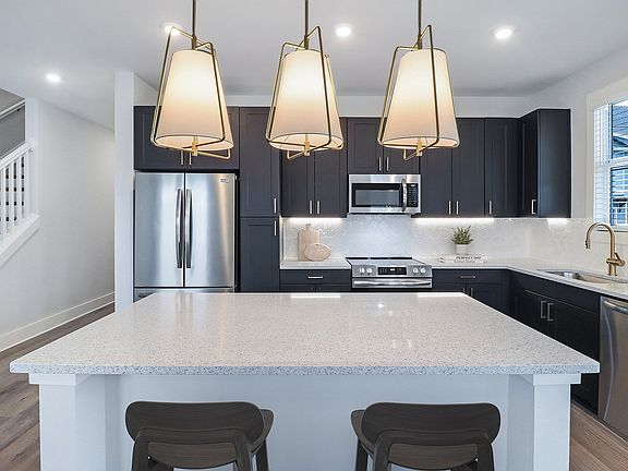 Sleek, two-toned European kitchen cabinets with under-cabinet lighting &amp; soft-close doors &amp; drawers
