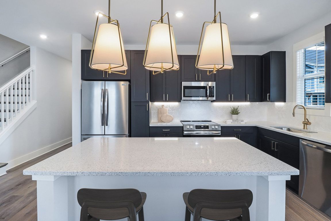 Sleek, two-toned European kitchen cabinets with under-cabinet lighting &amp; soft-close doors &amp; drawers