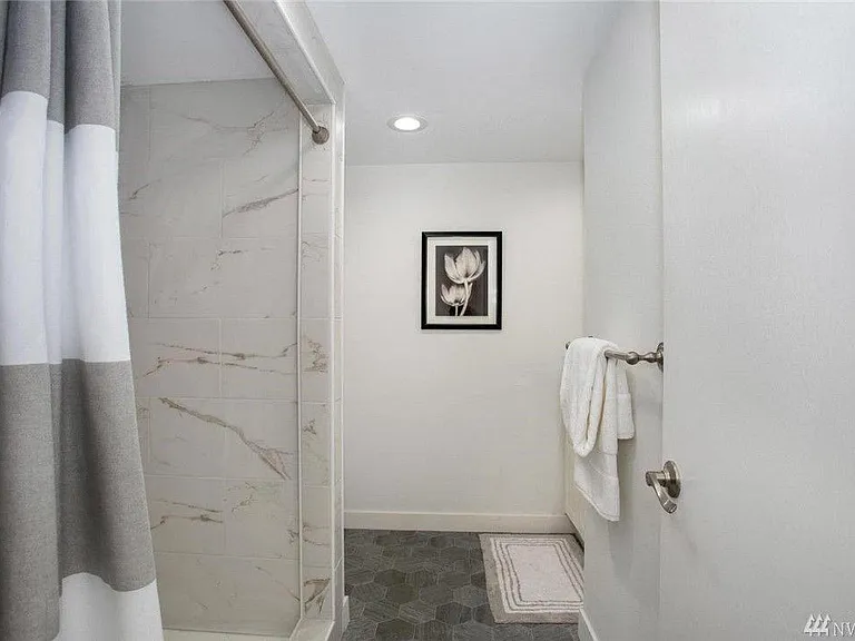 Bathroom updated w/ vanities, custom tiling, and modern finishes
