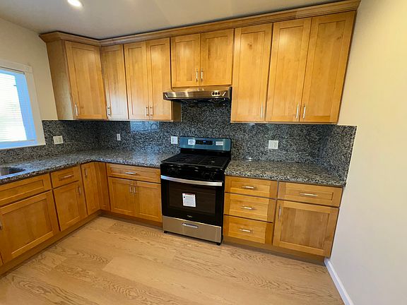 Brand new kitchen with granite countertops.