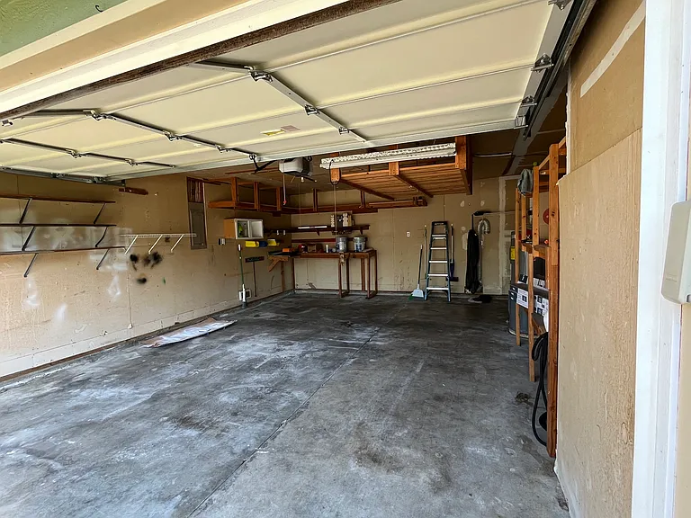2 car garage with work bench and laundry hook ups