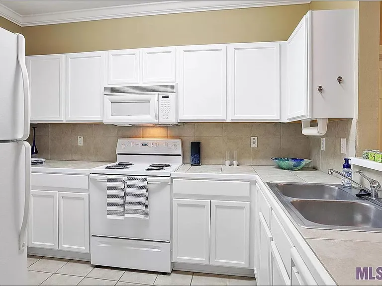 Kitchen with dishwasher, microwave and in-unit washer and dryer.