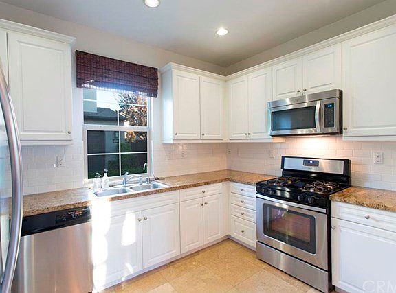 Updated Gourmet Kitchen with Granite Natural Stone Counter tops, with subway tile back splash, and s