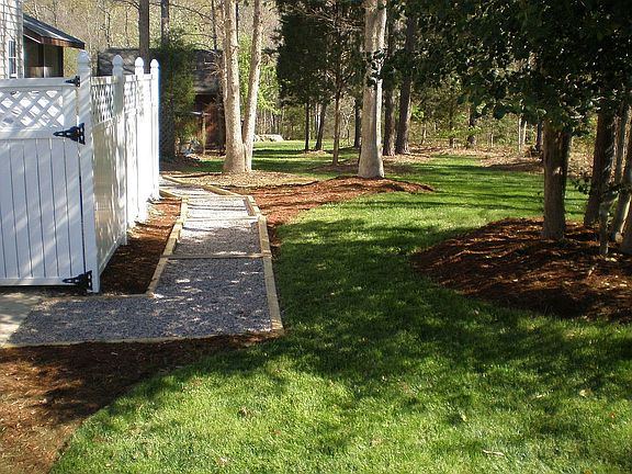 pea gravel path leading to back yard