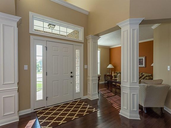 Elegant formal entry with custom trim work throughout. This view shows the formal living room off the entry.