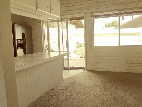Dining room area and kitchen - looking out to a inviting back patio.