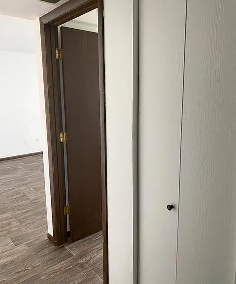 View of bedroom door and linen closet.