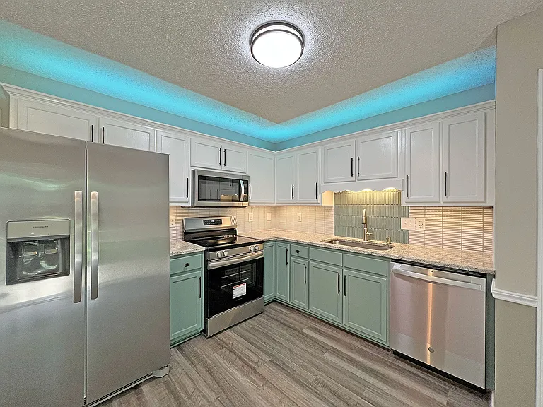 Full suite of SS appliances, custom tile backsplash, granite counter tops, over and under LED cabinet lighting