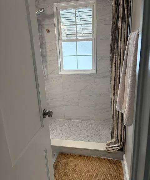Bathroom will have a walk-in tiled shower with built in seat/bench. No window inside the shower. Tile will be the same on the walls.