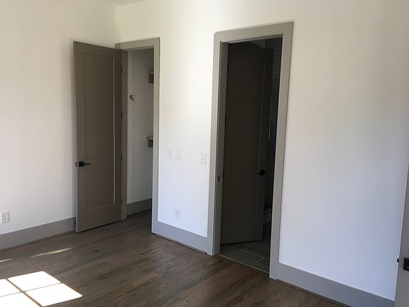 Downstairs primary bedroom - view of closet and entrance to primary bathroom. (note: the paint color for this room only varies from this photo)