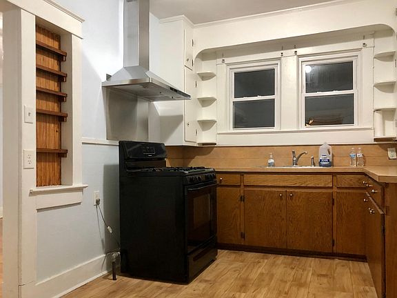 Spacious kitchen with new stainless steel hood.