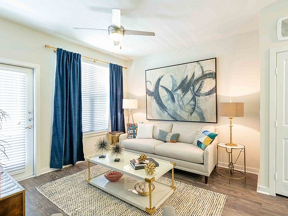 Brightly lit living room featuring wood-plank style flooring