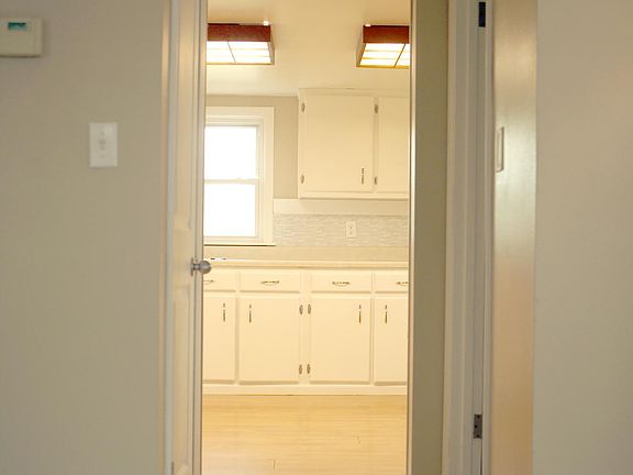 Hall from Family Room to Kitchen (half bath on right and basement door on left)