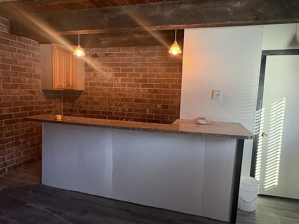 Kitchen Area with Stove and Refrigerator.