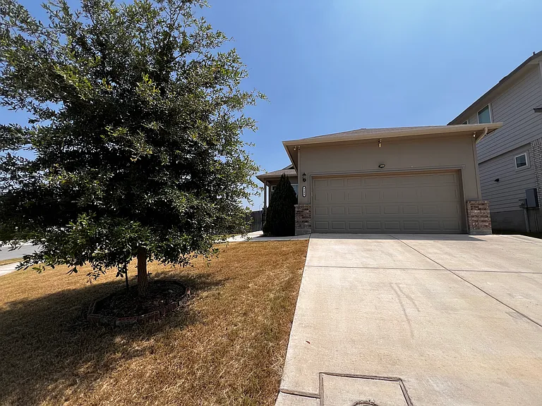Front of house, extended driveway, garage