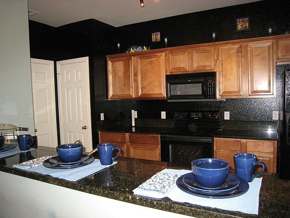 Granite Countertops and Warm Wood Cabinets in Kitchen