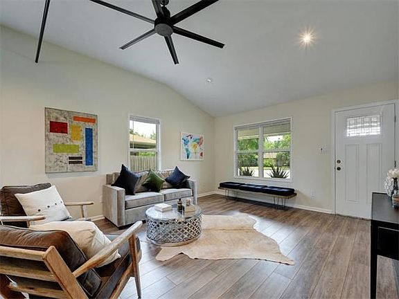 Completely open to the kitchen with windows that bathe the room with natural sunlight.