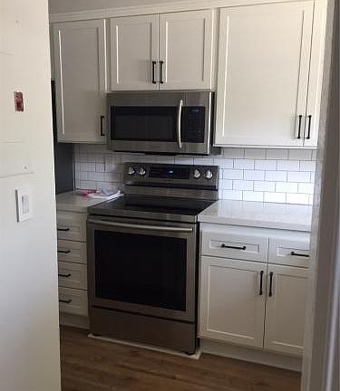 Upgraded kitchen, quartz countertop, shaker cabinets, stainless steel appliances.