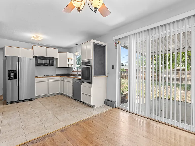 A charming dining nook sits just off the kitchen, with sliding-door access to the covered patio for easy indoor-outdoor living and entertaining.