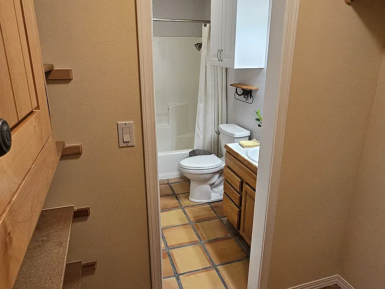 Walk in closet looking to bathroom