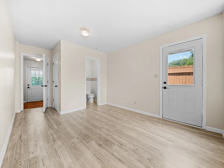 Bedroom with Ensuite Half Bath and Exterior Exit