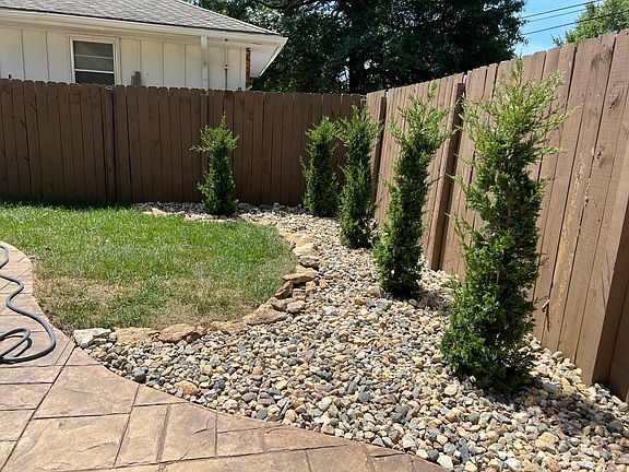 Fenced-in backyard with new landscaping