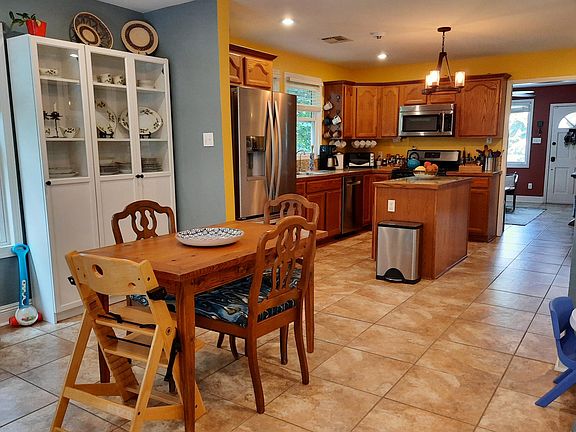 Open kitchen floorplan leads to the dining area with a built-in china cabinet