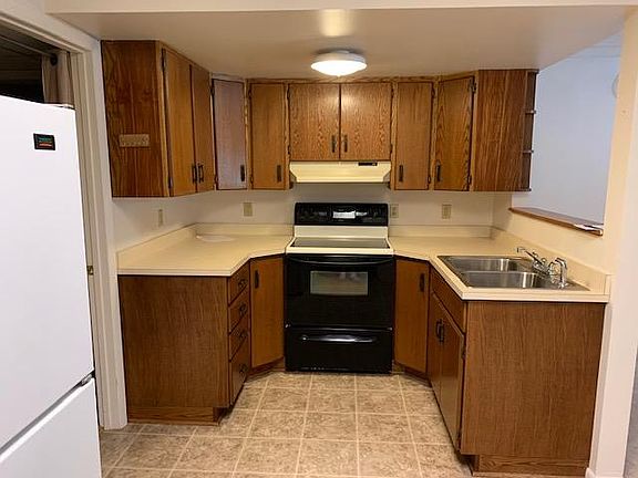 Kitchen with Electric Stove and Refrigerator