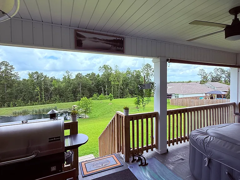 Spacious back porch with beautiful views of the pond and the woods.