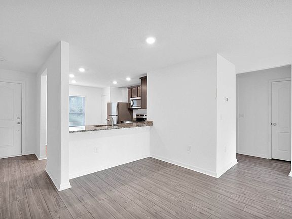 Overlooking the spacious family room, the sprawling granite countertops are sure to impress