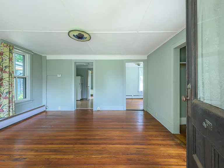 Three professional photos made pre-improvements on a less dreary day give better sense of scale and light in living room.