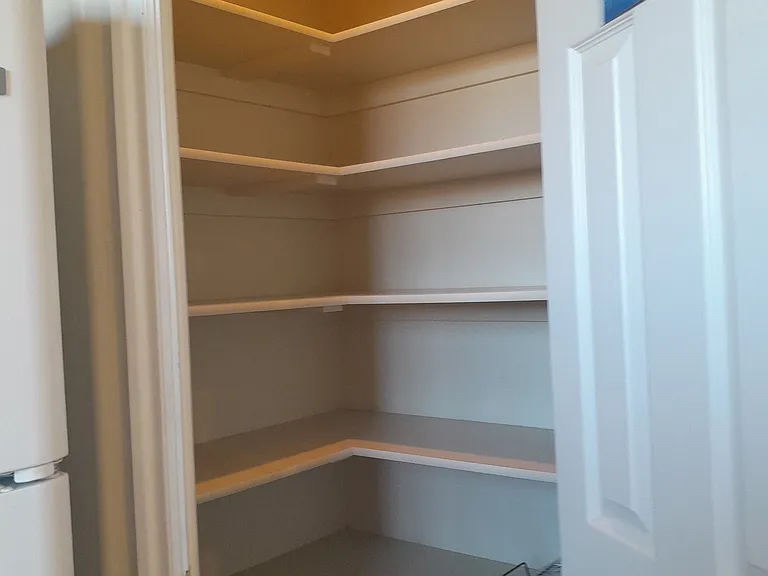 walk-in pantry many high shelves