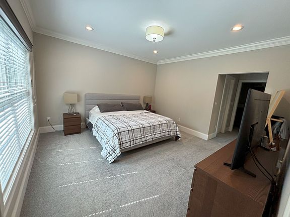 Main floor, main bedroom suite with walk in closet and full bathroom attached. Carpet flooring.