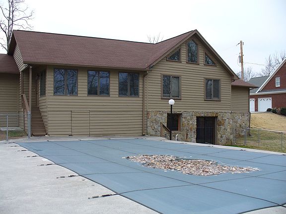 back of house with in-ground pool