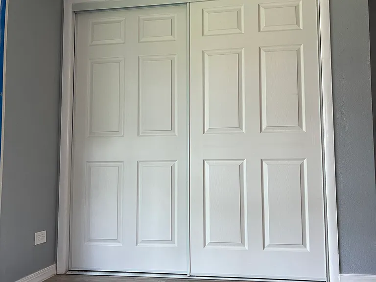 Large double-hanging closet and shelves in large primary bedroom.