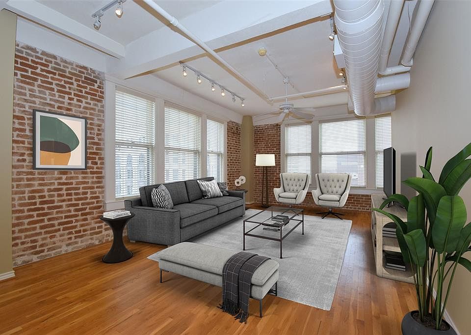 Desirable corner unit in historic Franklin Lofts, VIRTUALLY STAGED. Exposed brick walls provide a sense of true loft living. This unit comes with 2 assigned parking spaces and so much natural light.
