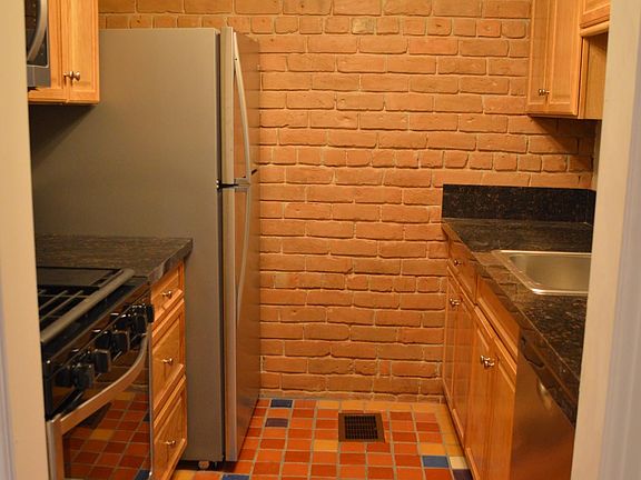 Kitchen with exposed brick wall